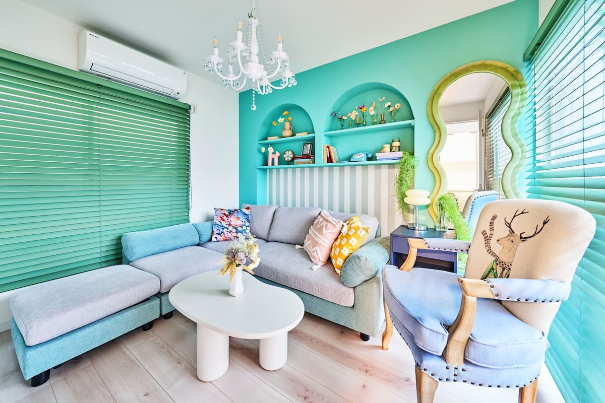 Living room with turquoise arches, chandelier and sofa